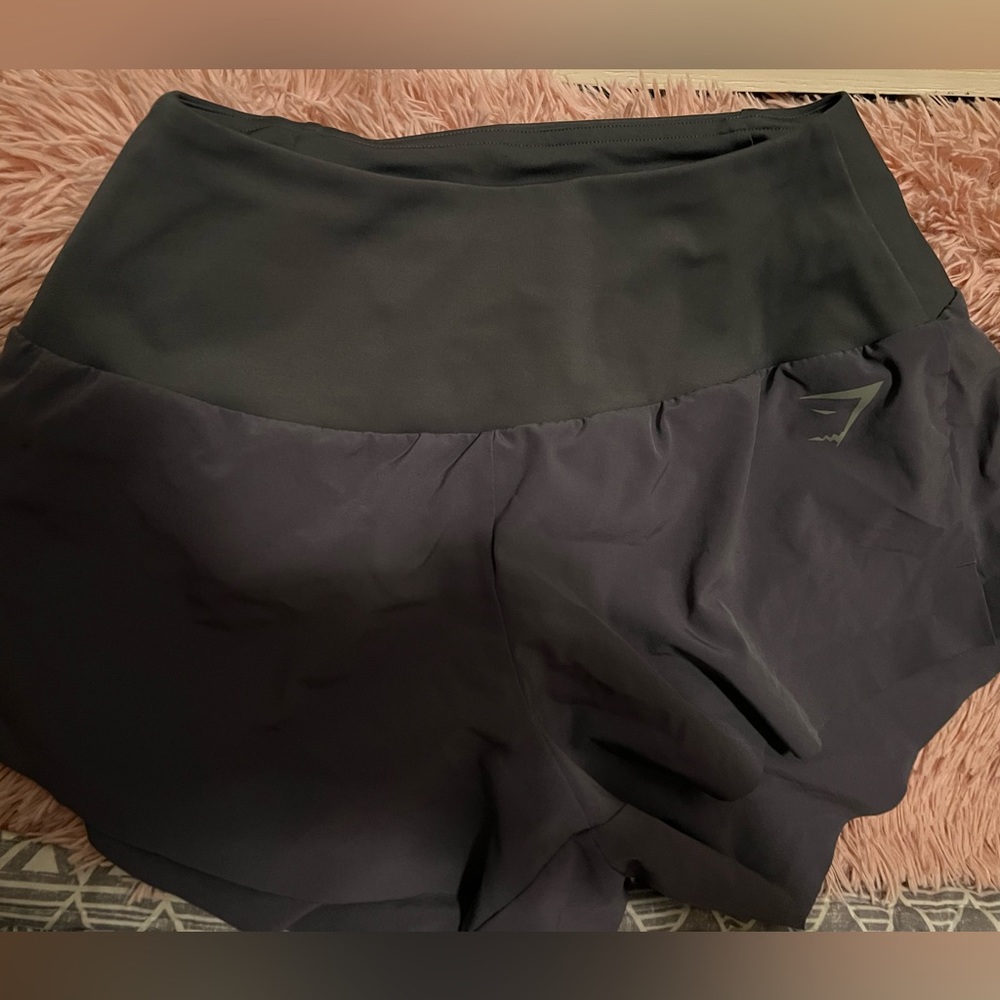 Grey gymshark running shirts with a back zipper pocket